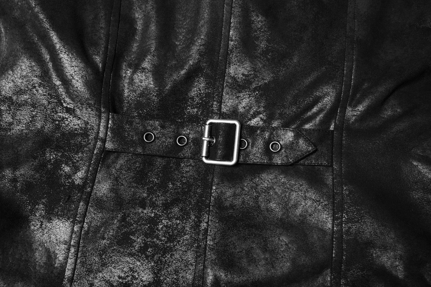 Close-up of a gothic black leather buckle on a long cape, showcasing durable woven fabric and stylish design.