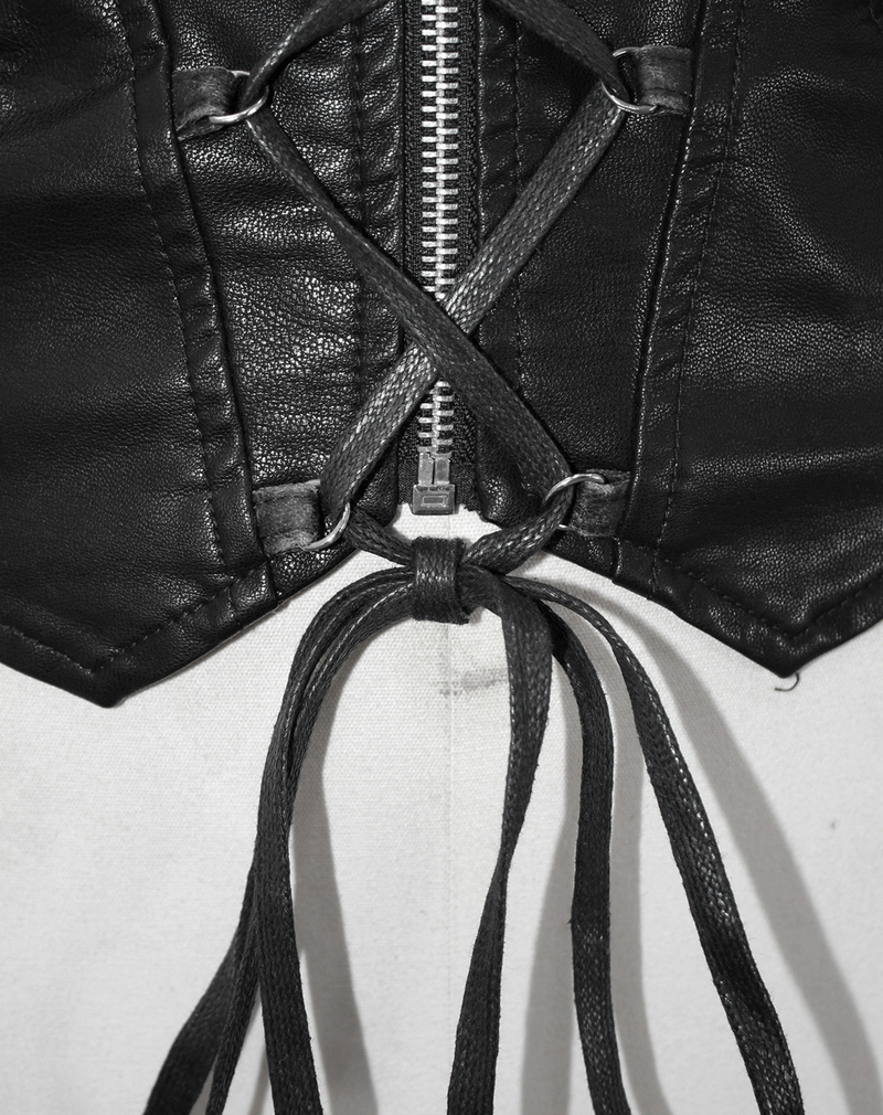 Close-up of gothic black zipper coat with lace-up detail and ties, showcasing edgy retro fashion.