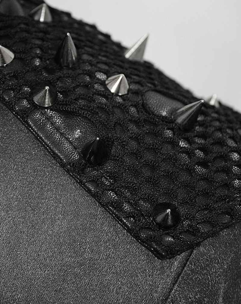 Close-up of black coat shoulder featuring studs and lace mesh for gothic style.