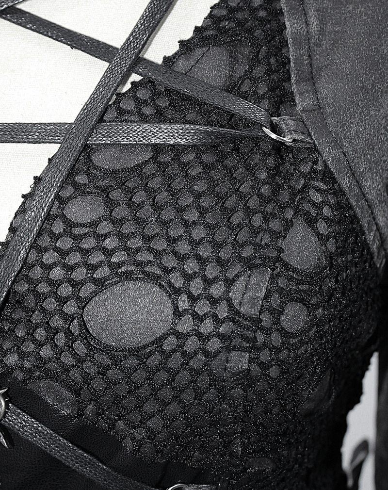 Close-up of gothic-style black lace with intricate patterns and straps for a trendy women's coat.