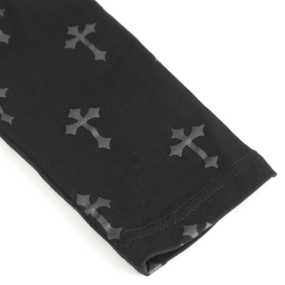 Close-up of Gothic lace-up leggings featuring dark cross pattern on a black fabric.