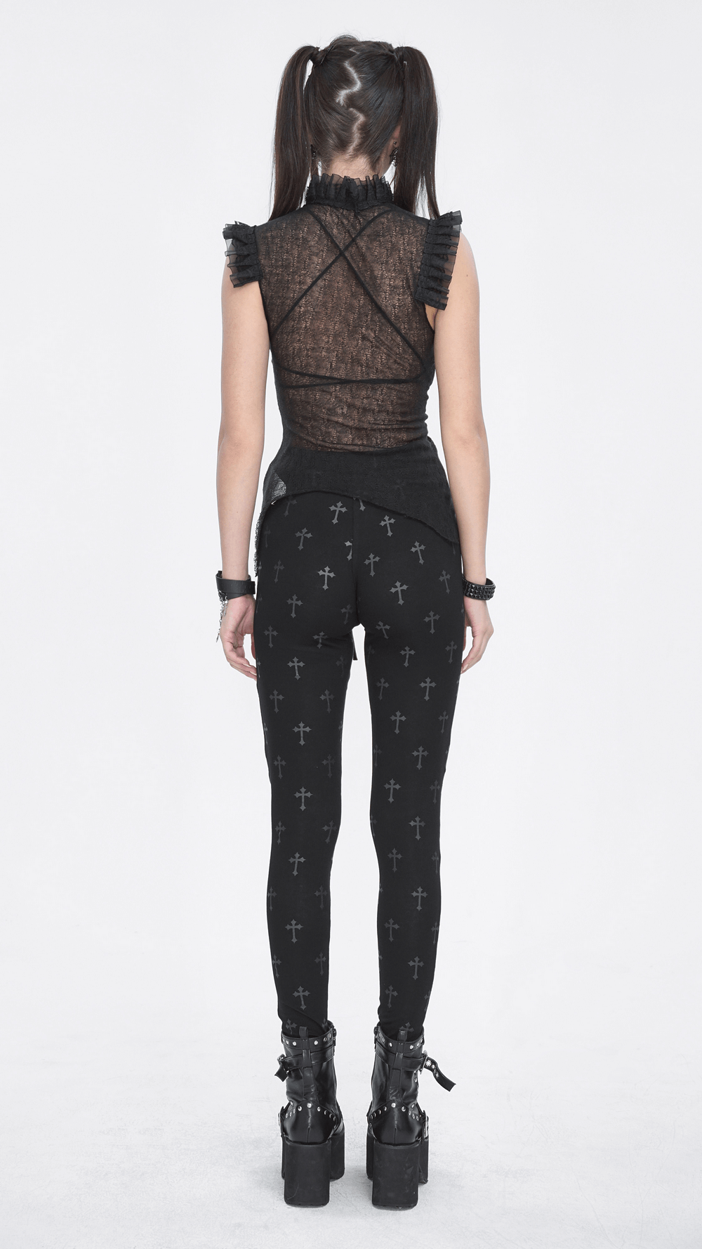 Back view of a woman in Gothic Cross Lace-up Leggings, showcasing a bold punk style with cross patterns.