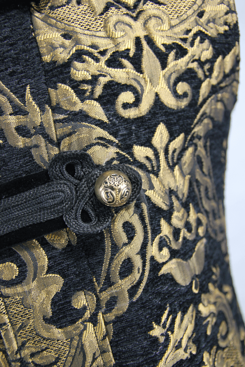 Close-up of gothic style embroidery and ornate gold button on a vintage men's sleeveless coat.