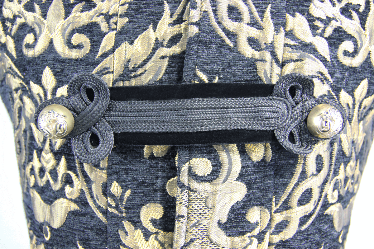 Close-up of the intricate gold embroidery and fastening on a gothic style men's sleeveless coat.