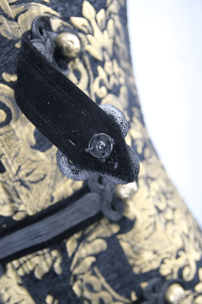 Close-up of gothic style embroidery detail with gold print on vintage men's coat.
