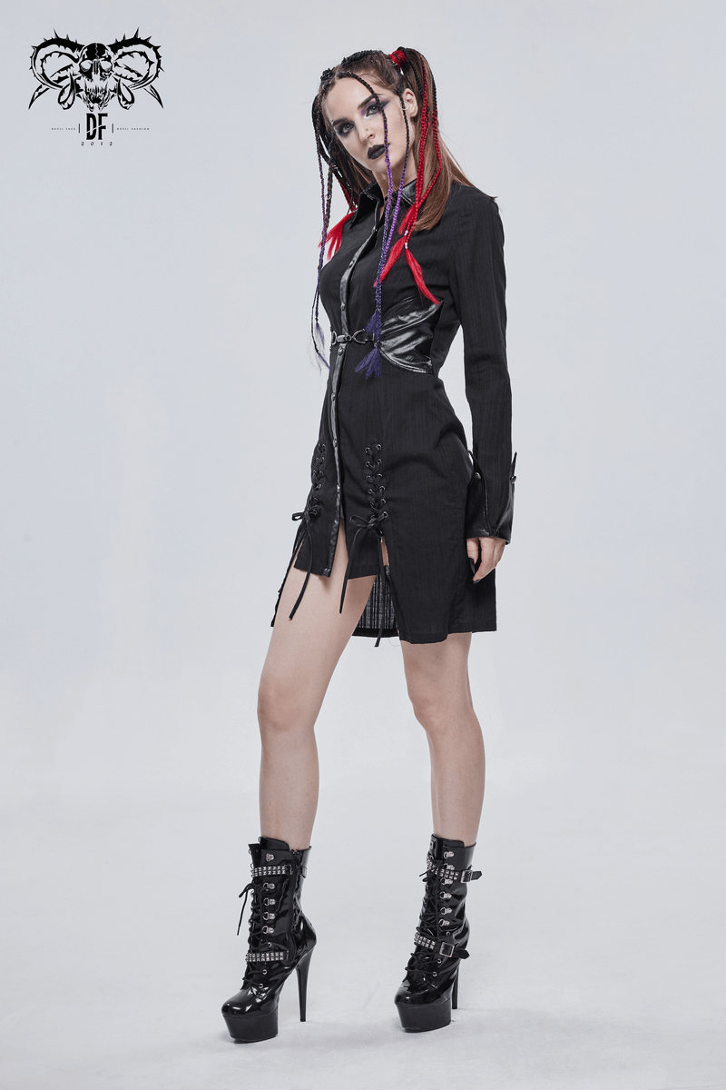 Gothic style female in a black punk rock dress with lace-ups and silver rivets, showcasing edgy fashion vibes.
