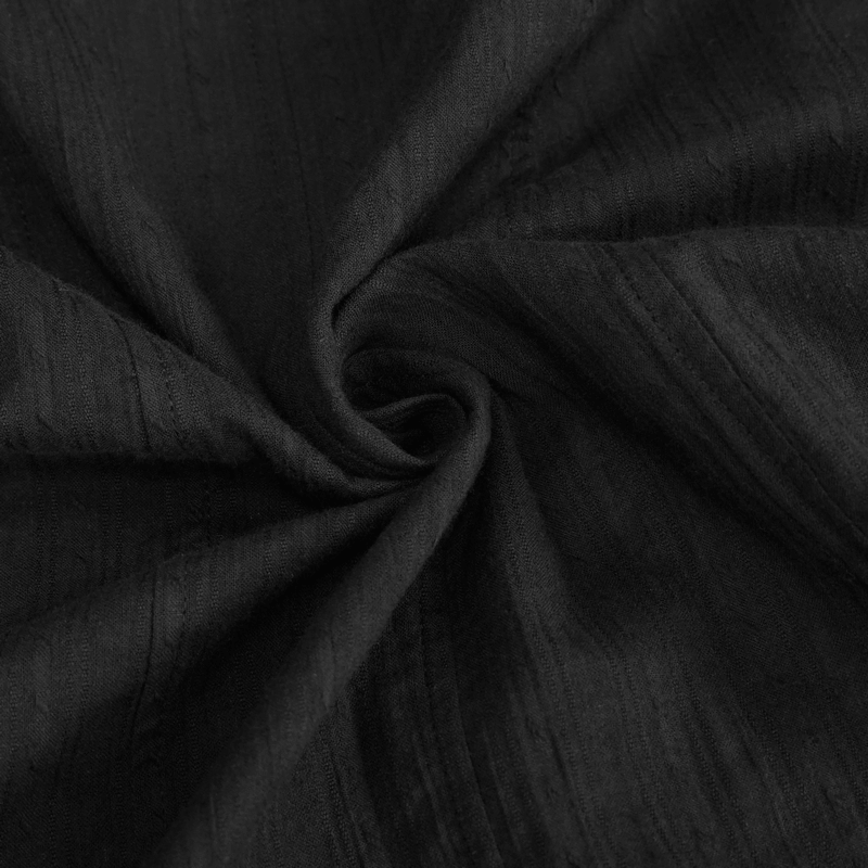 Close-up of textured black fabric, perfect for a punk rock style women's shirt dress.