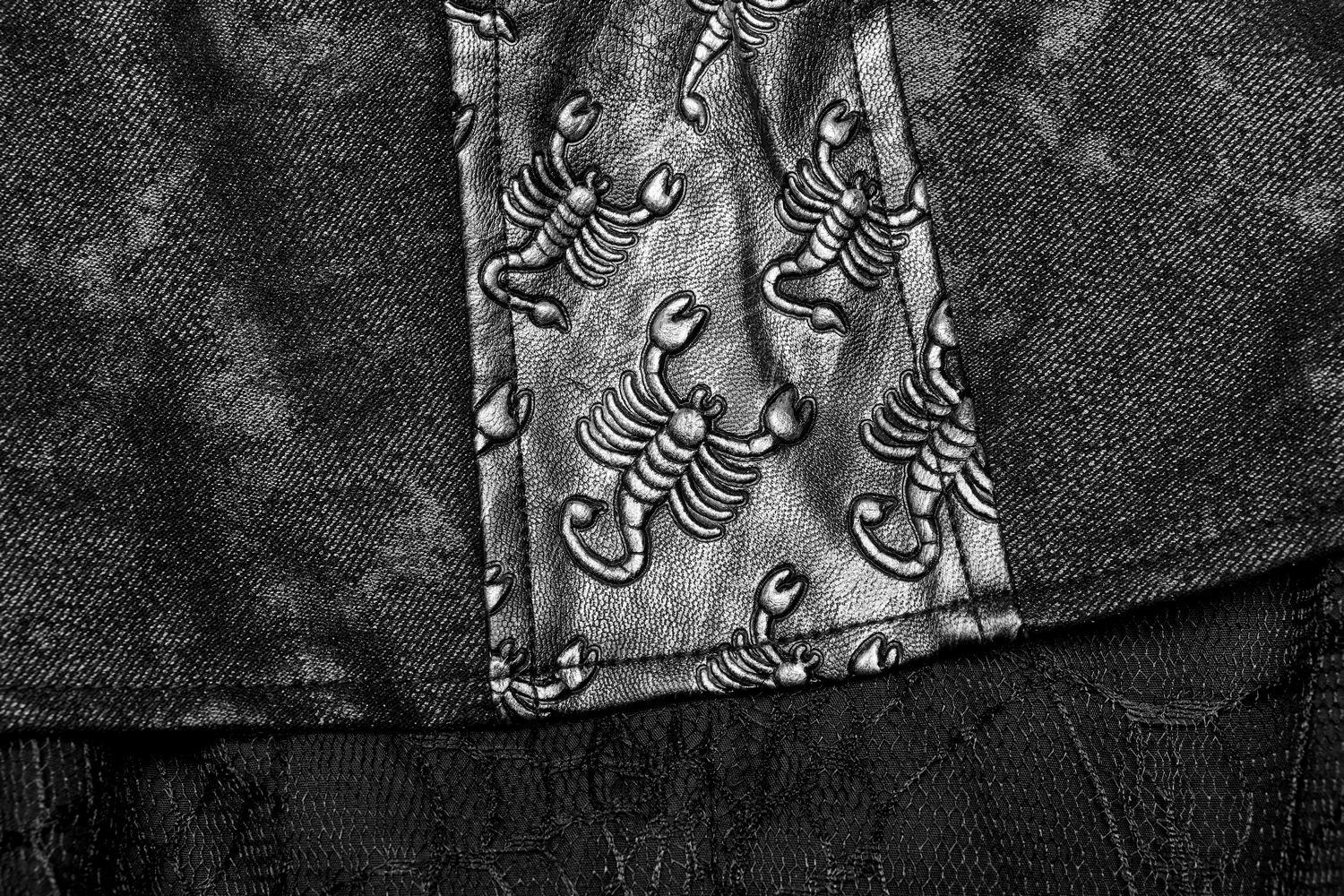 Close-up of Gothic fabric featuring scorpion patterns, showcasing intricate design elements for unique fashion.
