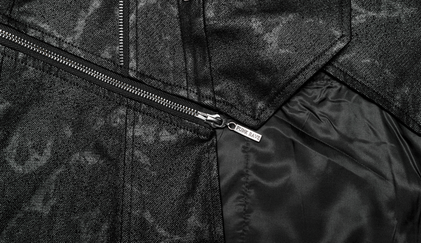 Close-up of Gothic style coat interior featuring sleek black fabric and detailed zipper hardware.