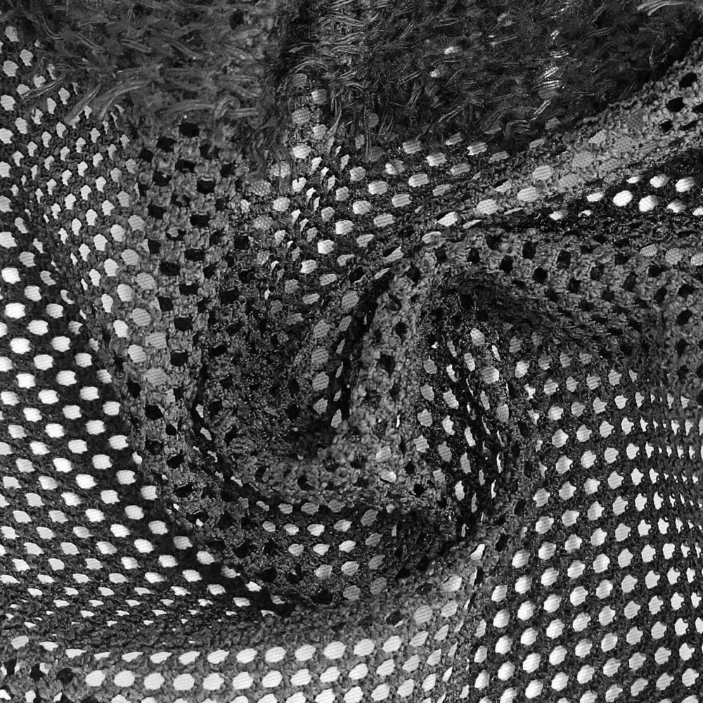 Close-up of black mesh fabric showing intricate holes, perfect for gothic style men's tops.
