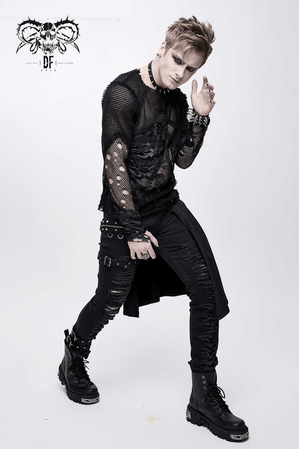 Gothic men's black mesh top with skull pattern, featuring torn inserts, styled with edgy black pants and boots.