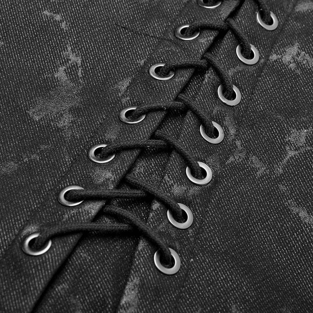 Close-up of black Gothic vest showcasing metal grommets and lace detail for an edgy, stylish look.