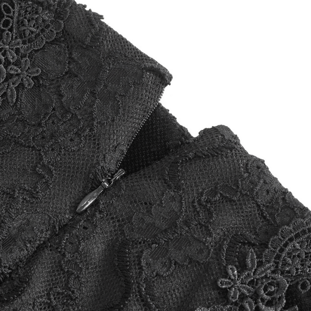 Close-up of gothic-style black skirt showing intricate lace details and zipper closure.