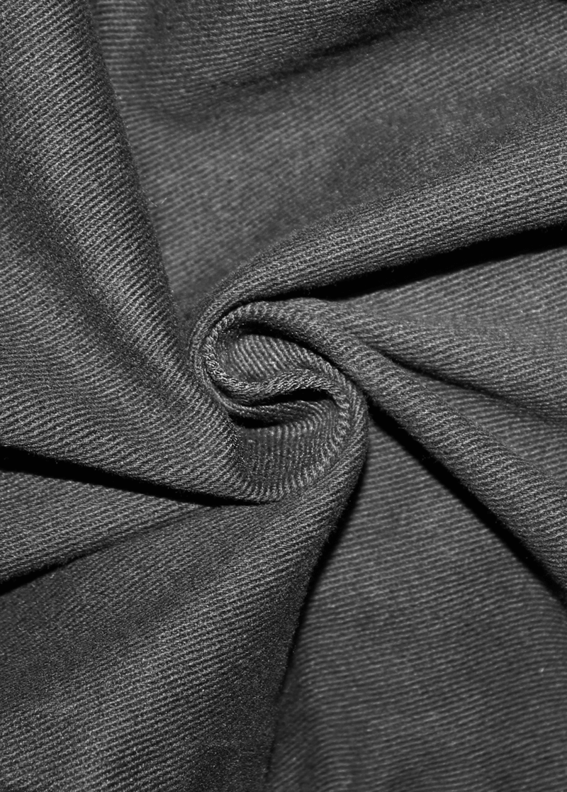 Close-up of black fabric showcasing its soft texture, perfect for gothic style clothing and men’s trousers.