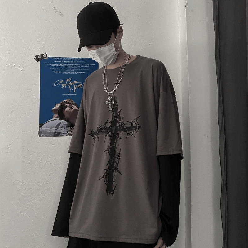 Gothic style oversized sweatshirt for men featuring a bold cross print, paired with a black long sleeve underneath.