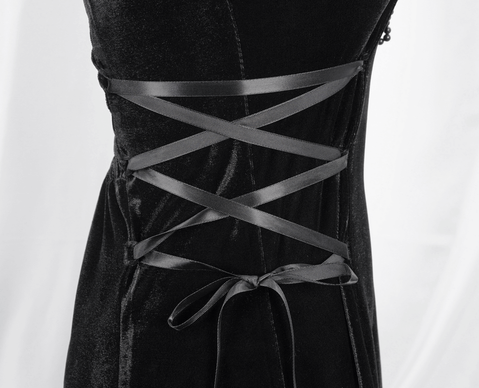 Close-up of black velvet gothic dress with lace-up detailing on the side, showcasing elegant style and premium fabric.
