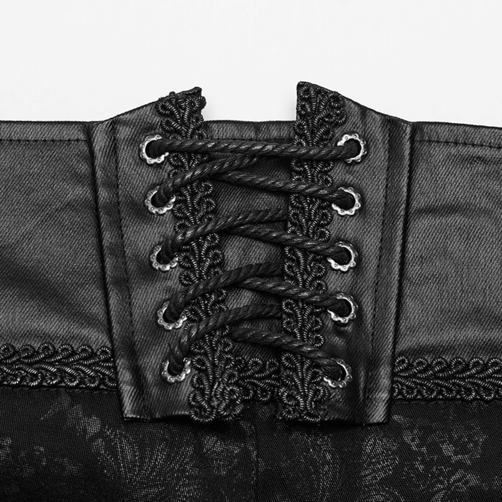 Close-up of gothic black lace-up detail on skinny jeans waistband, showcasing intricate stitching and edgy design.