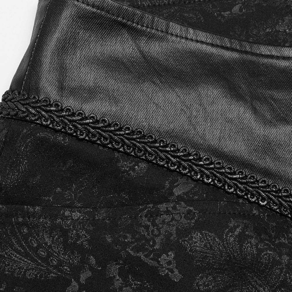 Close-up of gothic black textured skinny jeans with lace detailing and embossed fabric.