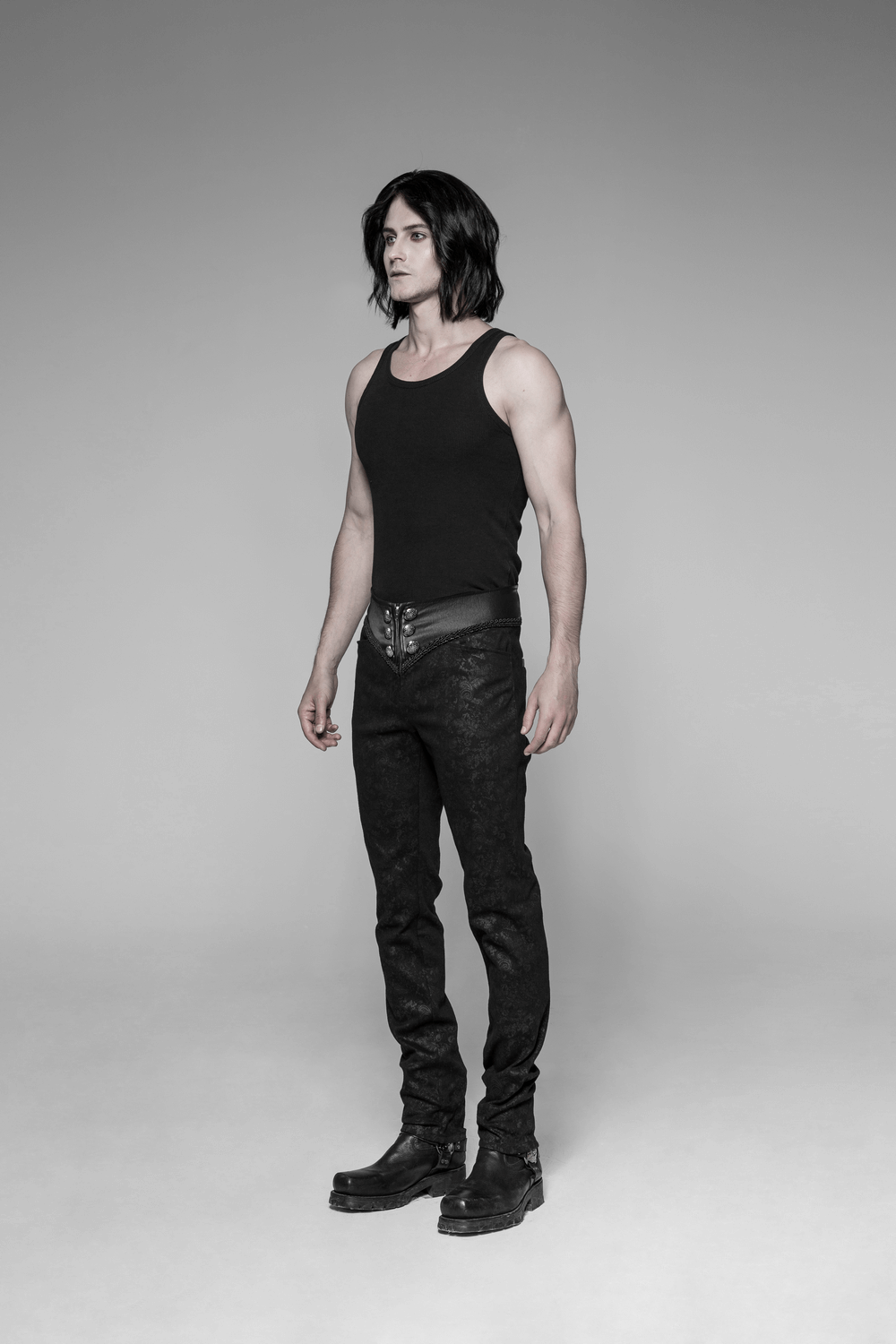 Gothic black skinny jeans with lace-up back, paired with a fitted tank top and boots for an edgy fashion statement.