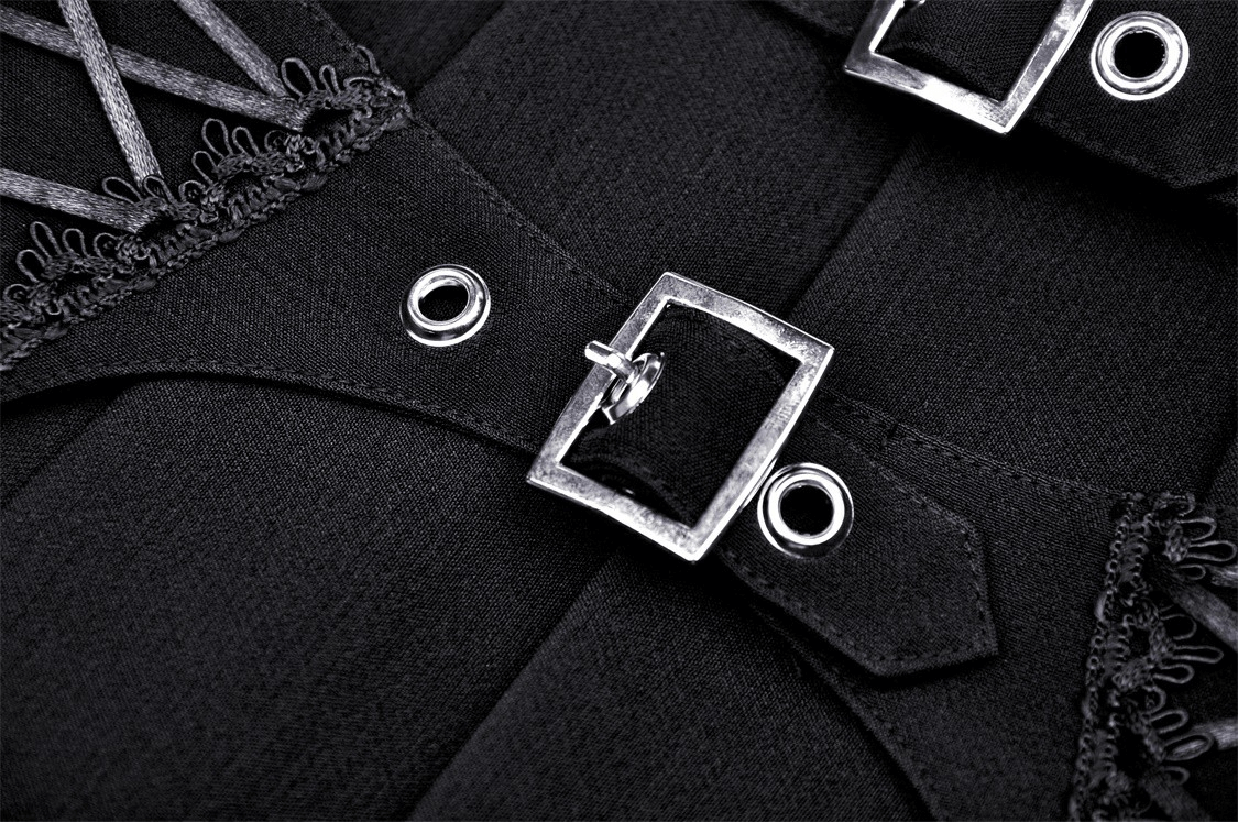 Close-up of a black pleated skirt featuring lace-up detail and silver buckle accents, showcasing stylish craftsmanship.