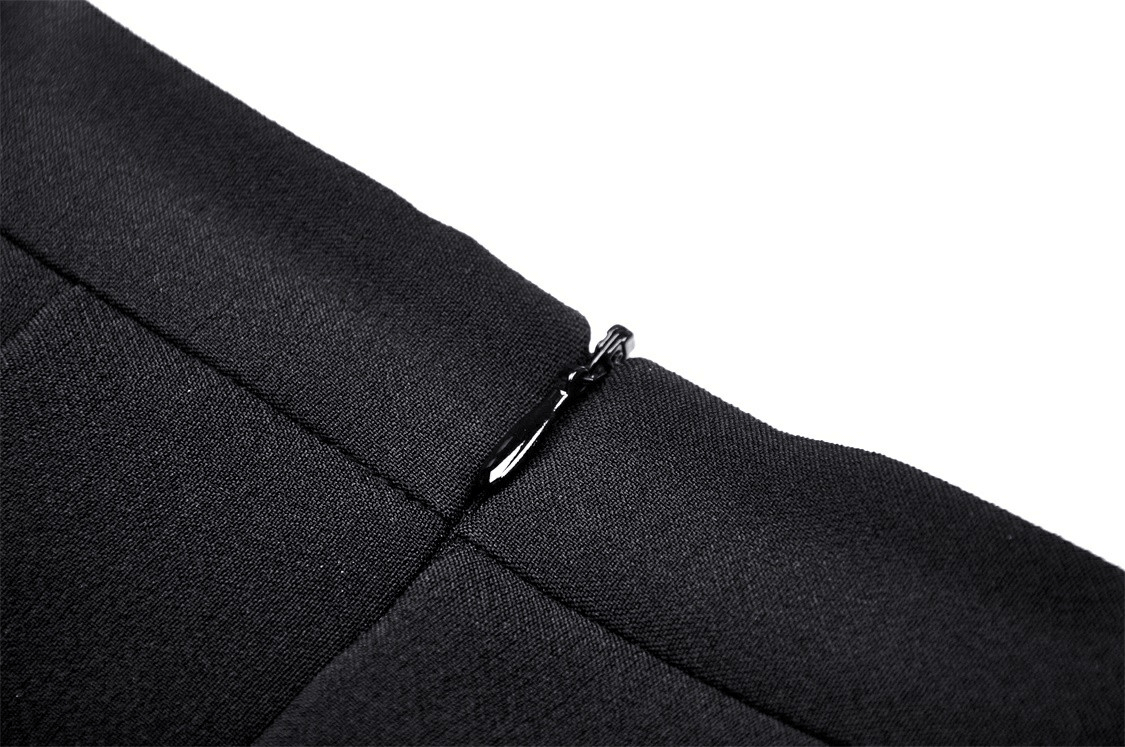 Close-up of a black pleated skirt showcasing the sleek zipper detail for stylish elegance.