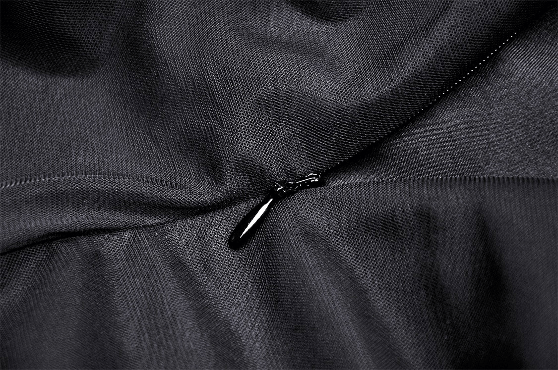Close-up of a black zipper detail on elegant gothic dress fabric, showcasing sophisticated dark fashion style.