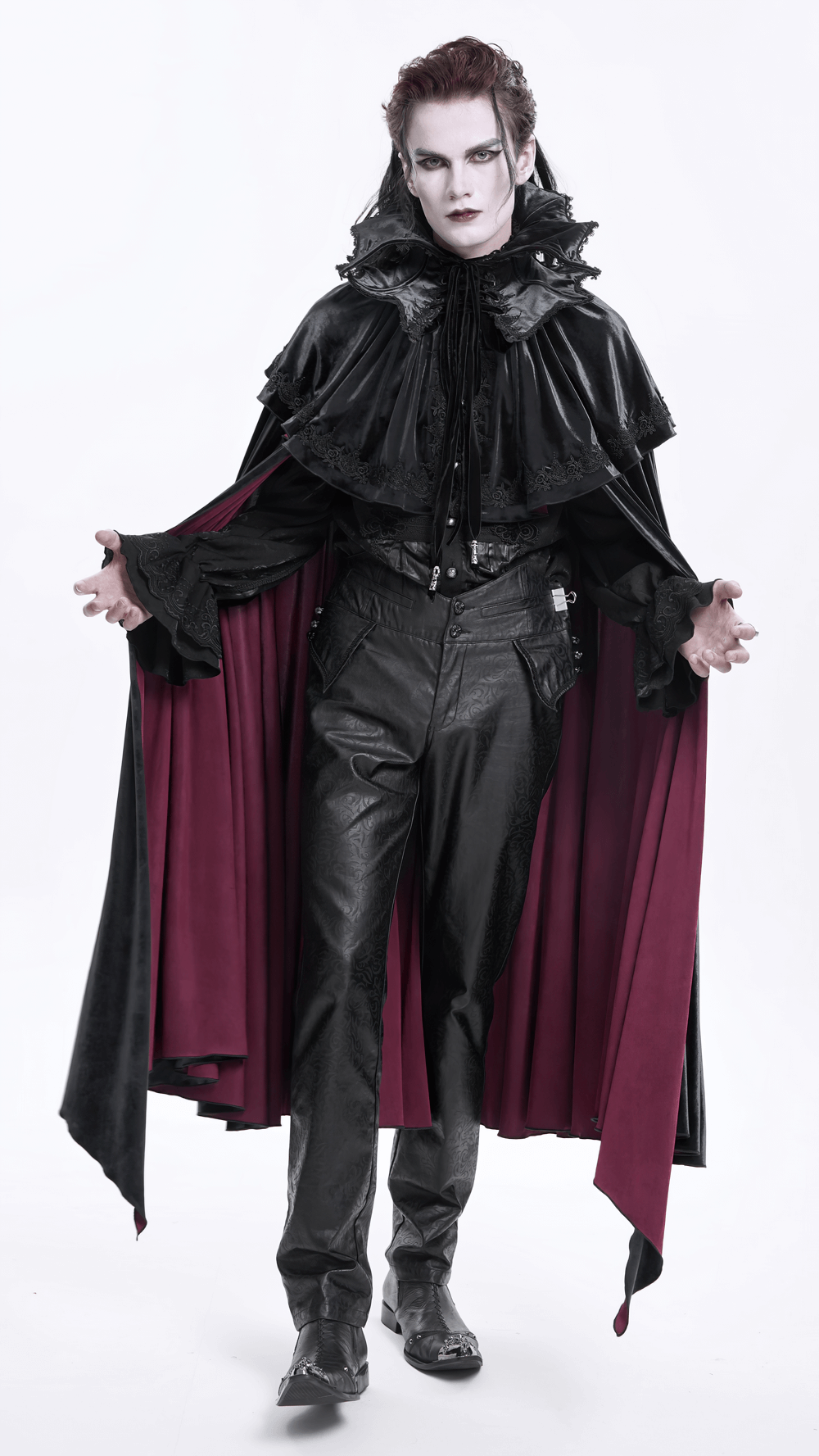 Dramatic figure in black and red cape with gothic makeup and leather pants, exuding a dark, stylish vibe.