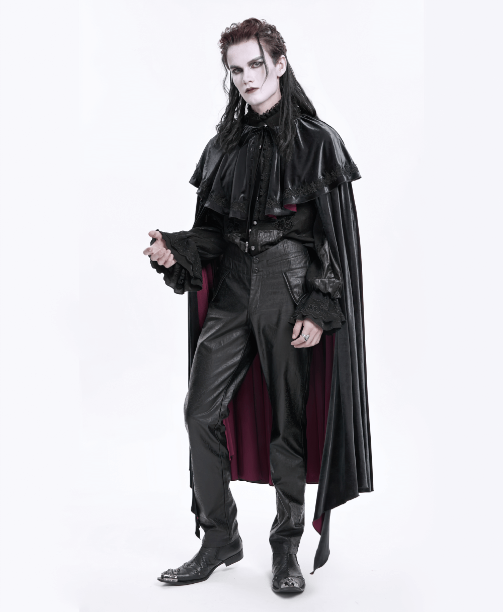 Gothic figure in black synthetic leather attire with a flowing cape and dramatic makeup, showcasing edgy fashion style.