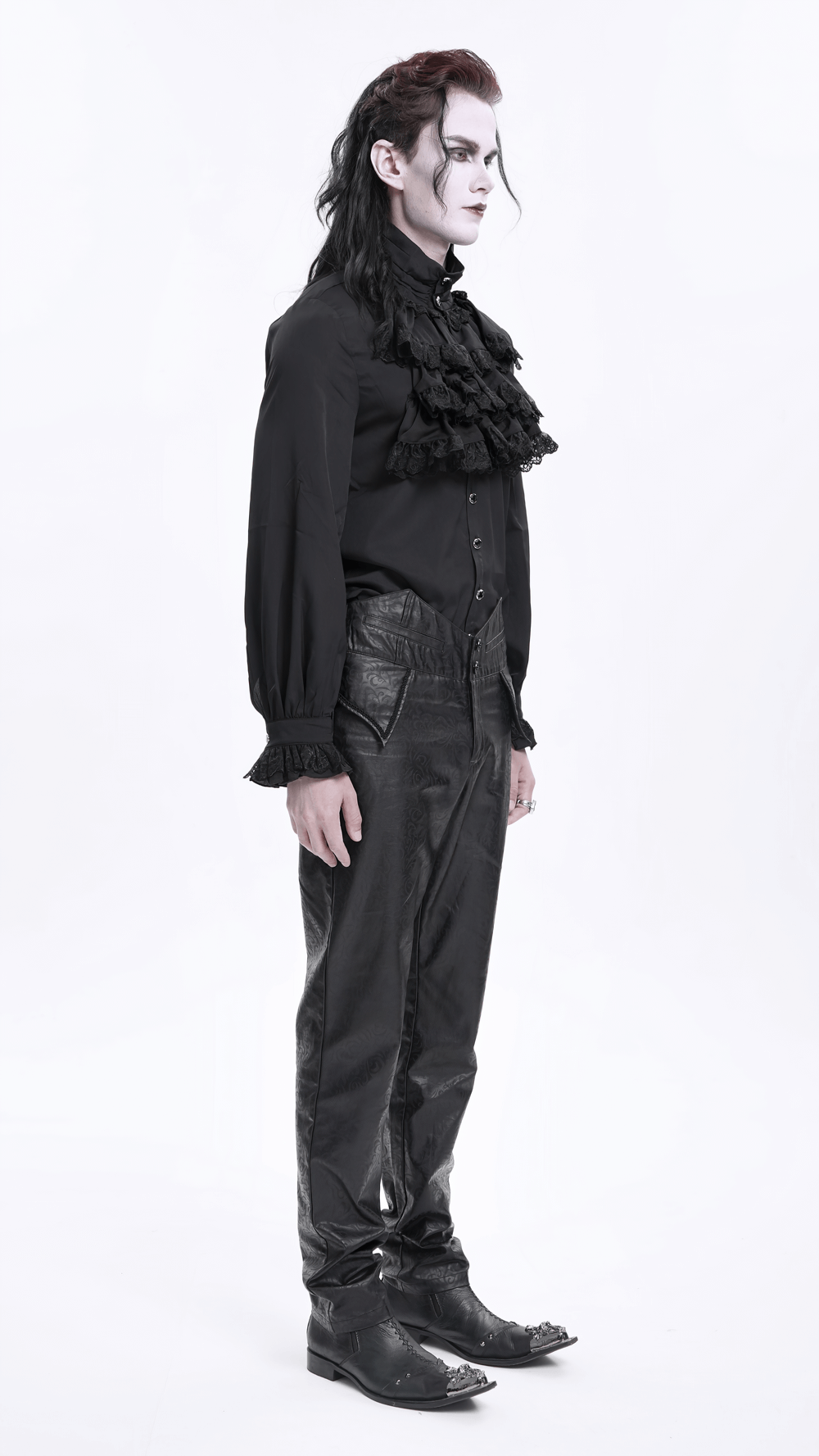 Model in gothic attire with ruffled top and synthetic leather pants, exuding a striking dark fashion vibe.