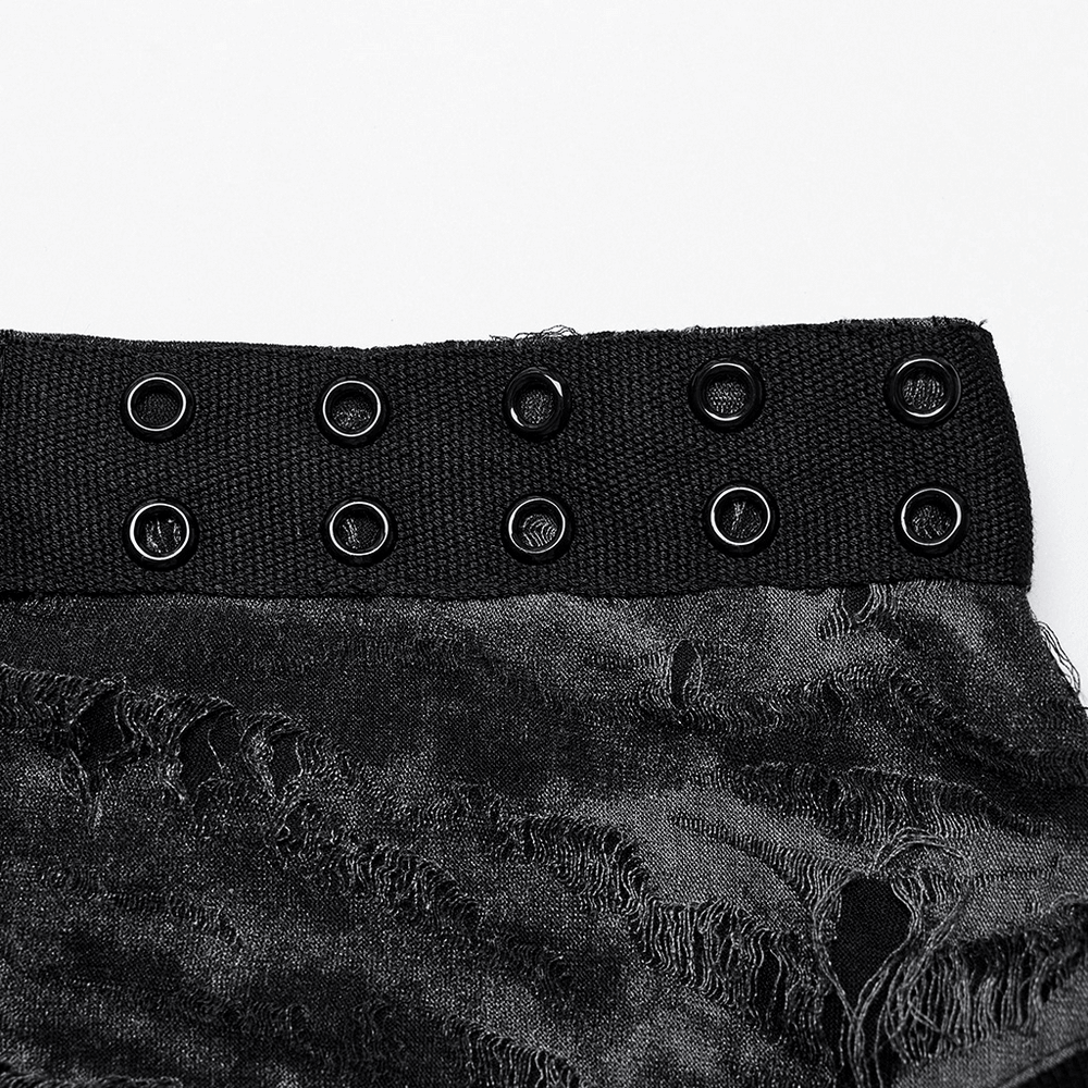 Close-up of Gothic tank top shoulder featuring eyelet webbing and tattered fabric texture.