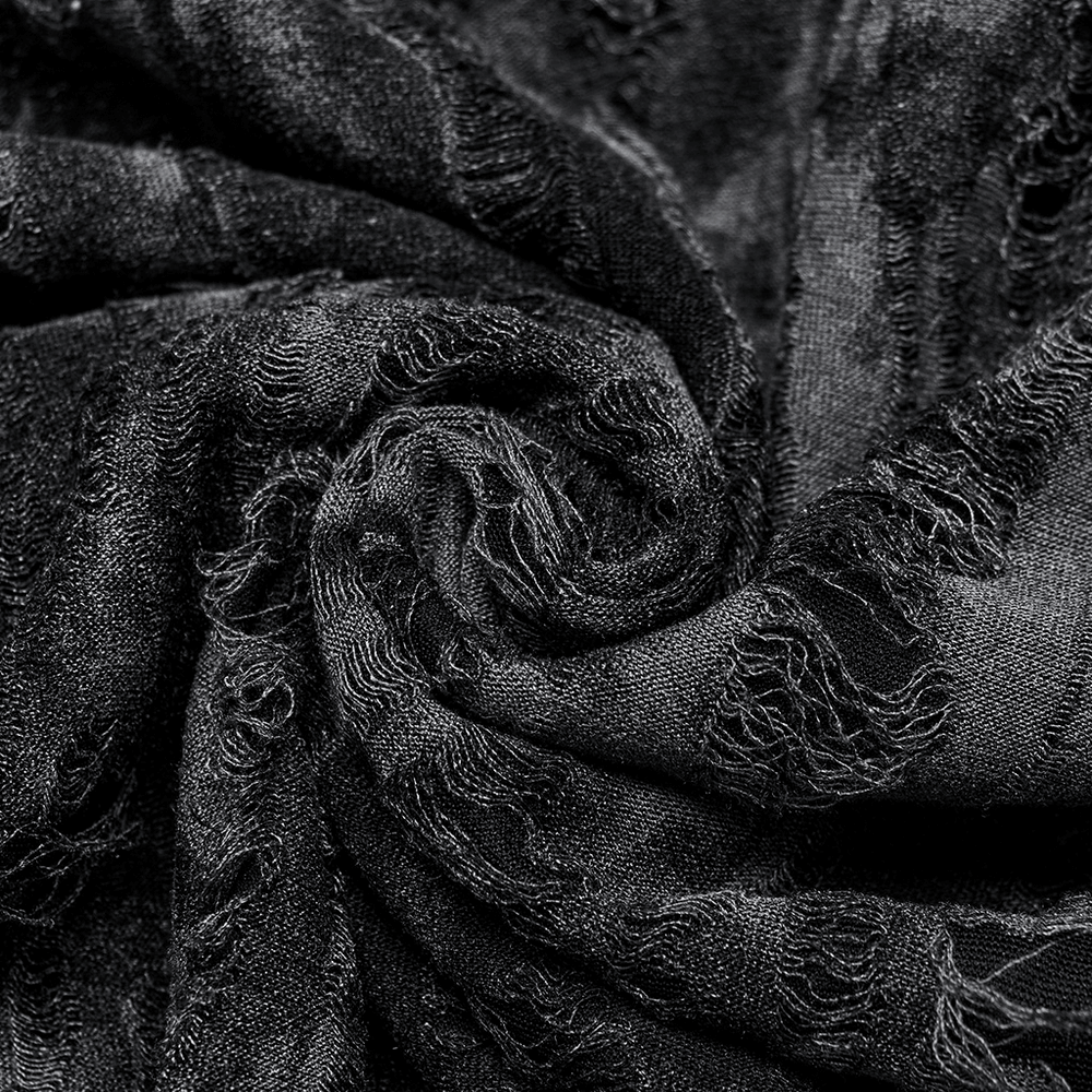 Close-up of tattered black fabric showcasing a textured, gothic style ideal for alternative fashion.