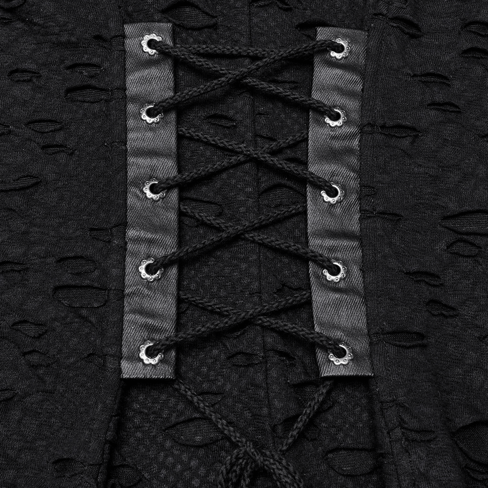 Close-up of gothic tattered mesh dress showing detailed black lace-up panel with silver grommets.