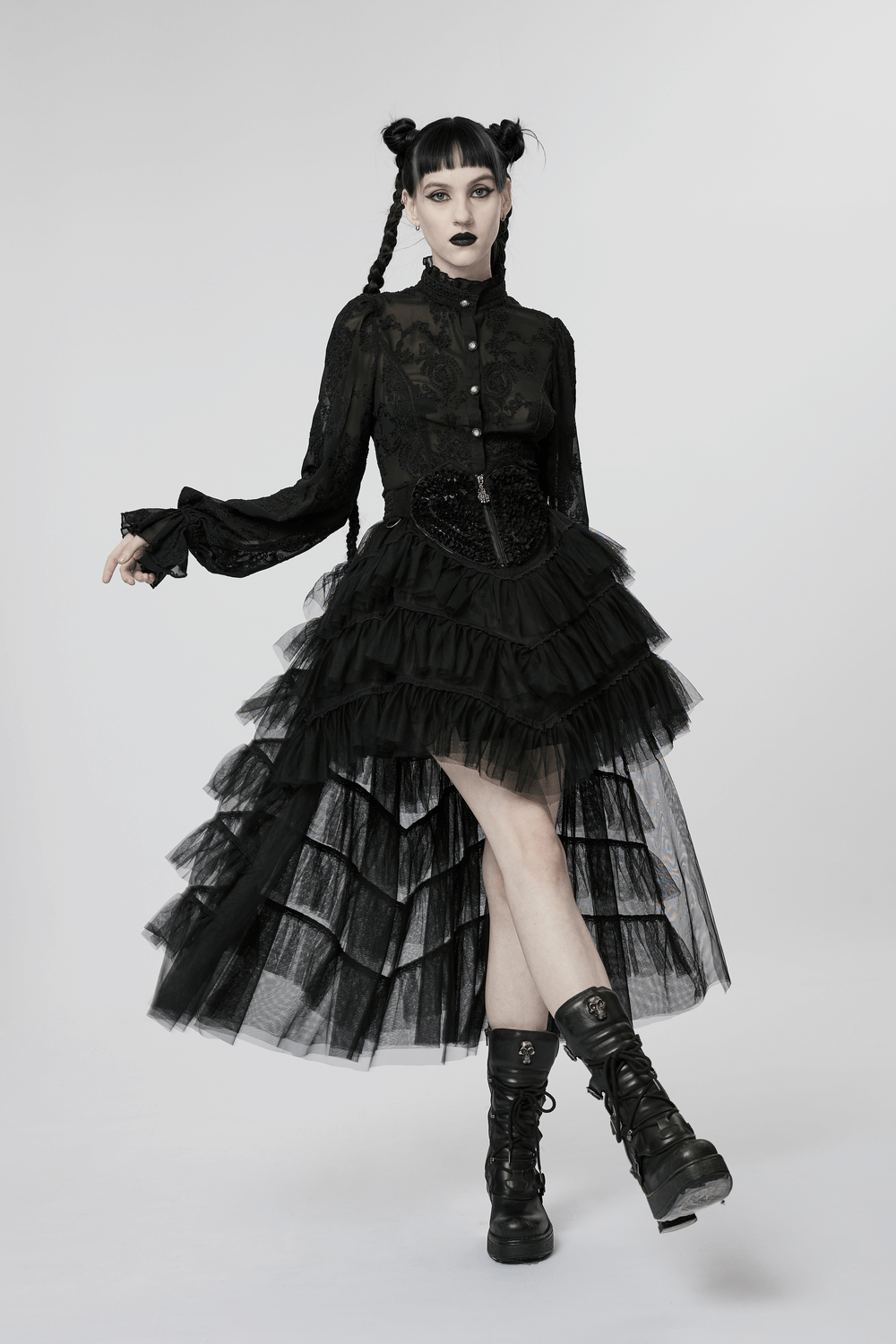 Model in a gothic tiered tulle ruffle skirt, showcasing a stylish layered design with a black top and edgy boots.