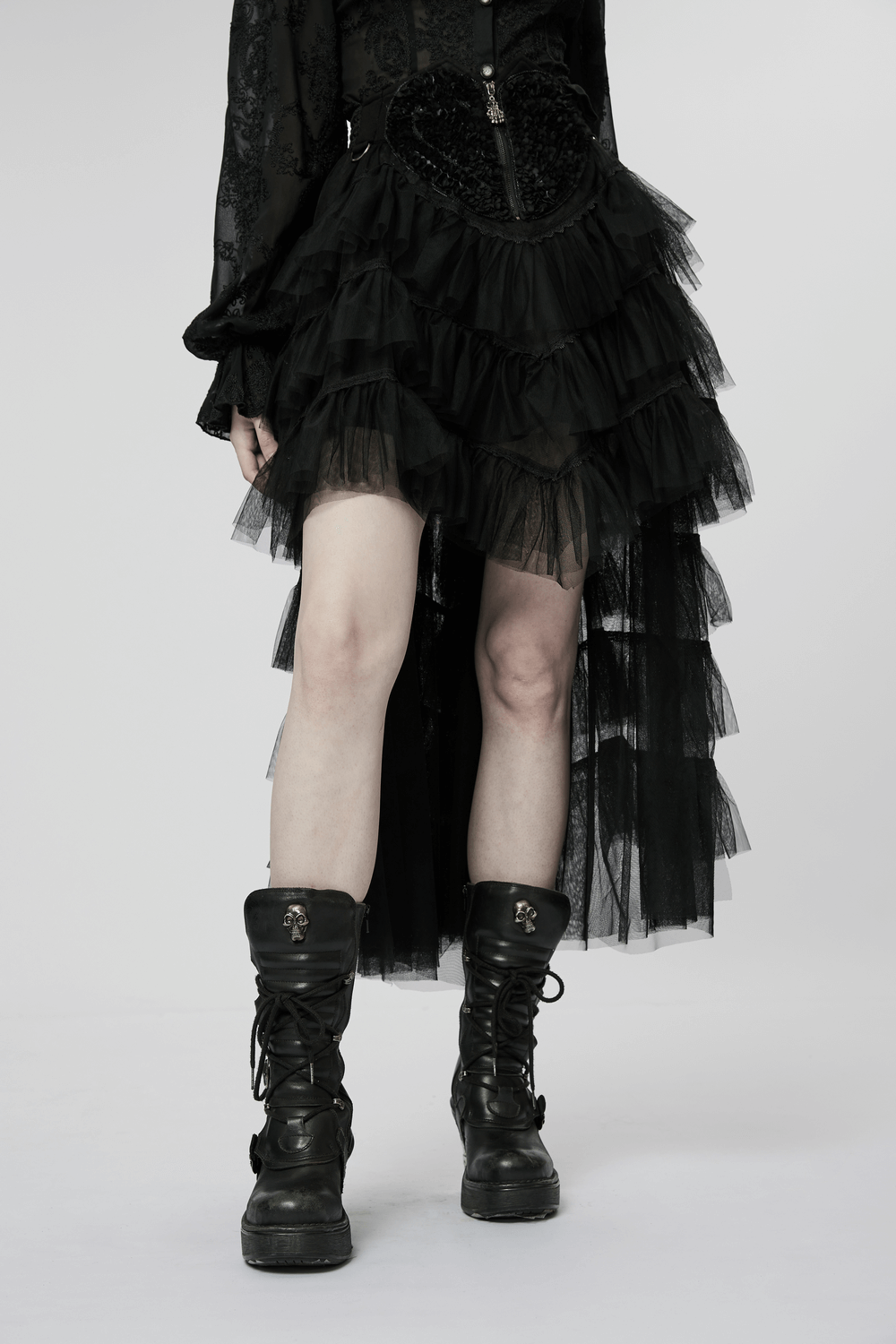 Gothic tiered tulle ruffle skirt with skeleton hand zipper, paired with black combat boots.