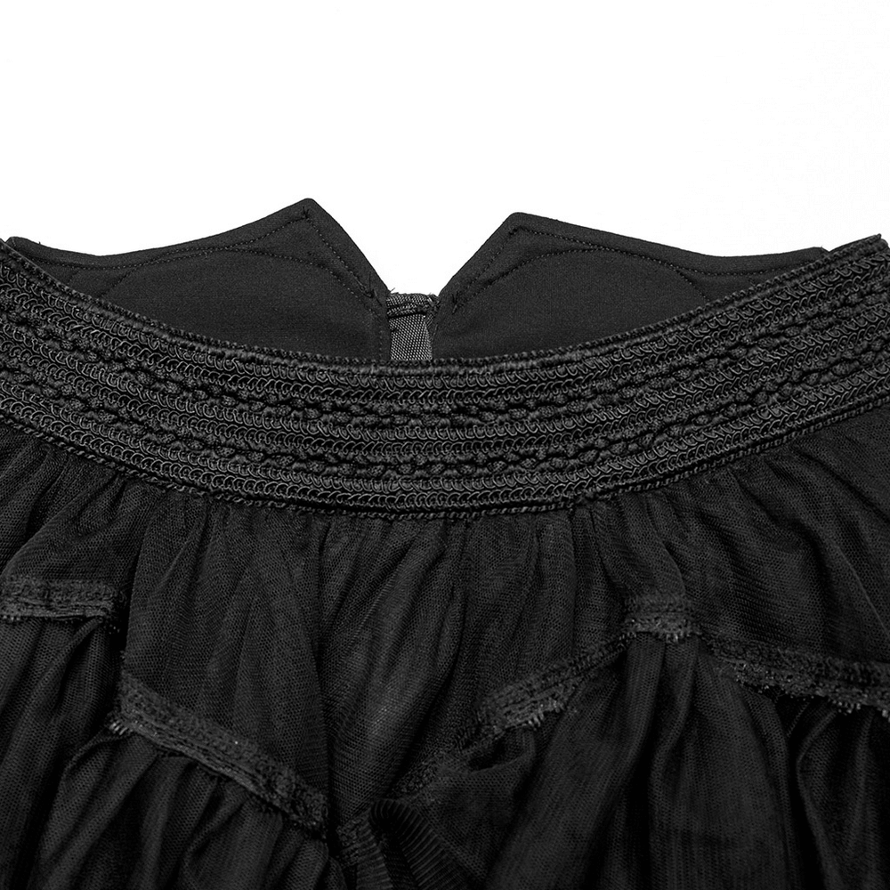 Close-up of the gothic tiered tulle ruffle skirt showcasing its smocked waistband and skeleton hand zipper detail.