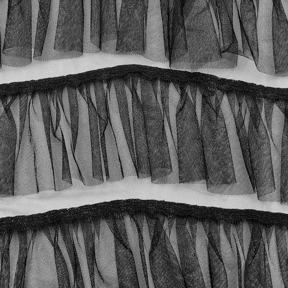 Close-up of black tulle ruffles, showcasing layered gothic texture and design for a chic, edgy style.