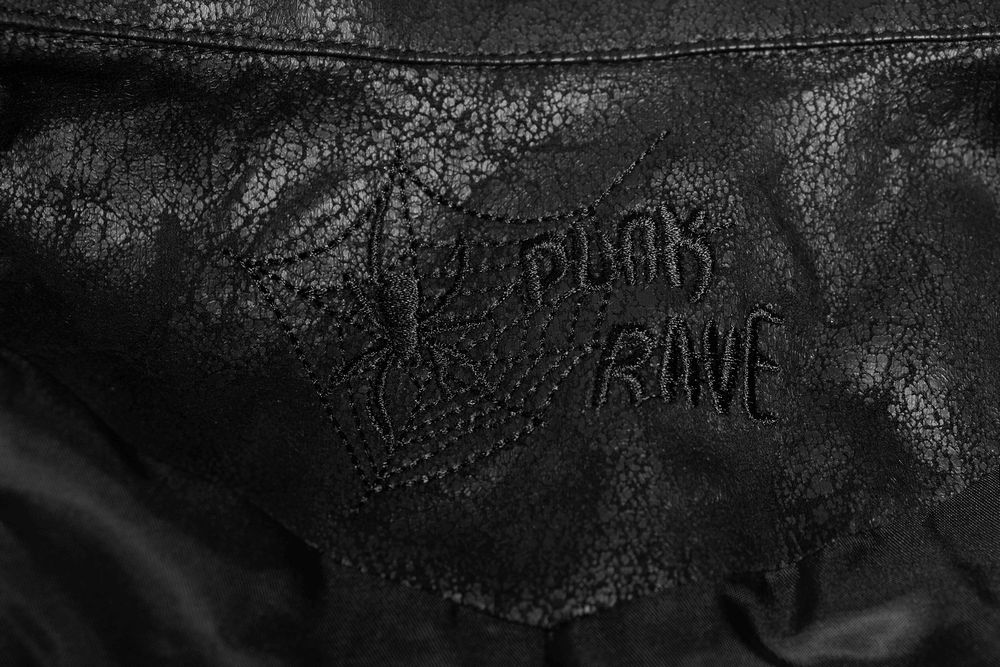 Close-up of the intricate spider logo and embroidery 'Punk Rave' on a black leather coat.