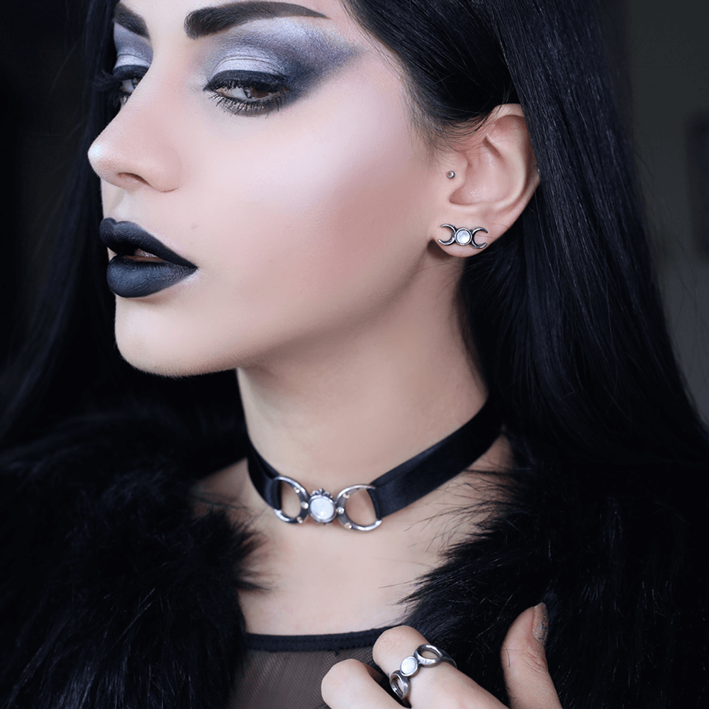 Model wearing Gothic Triple Goddess choker with moon and crystals, showcasing a striking dark look.