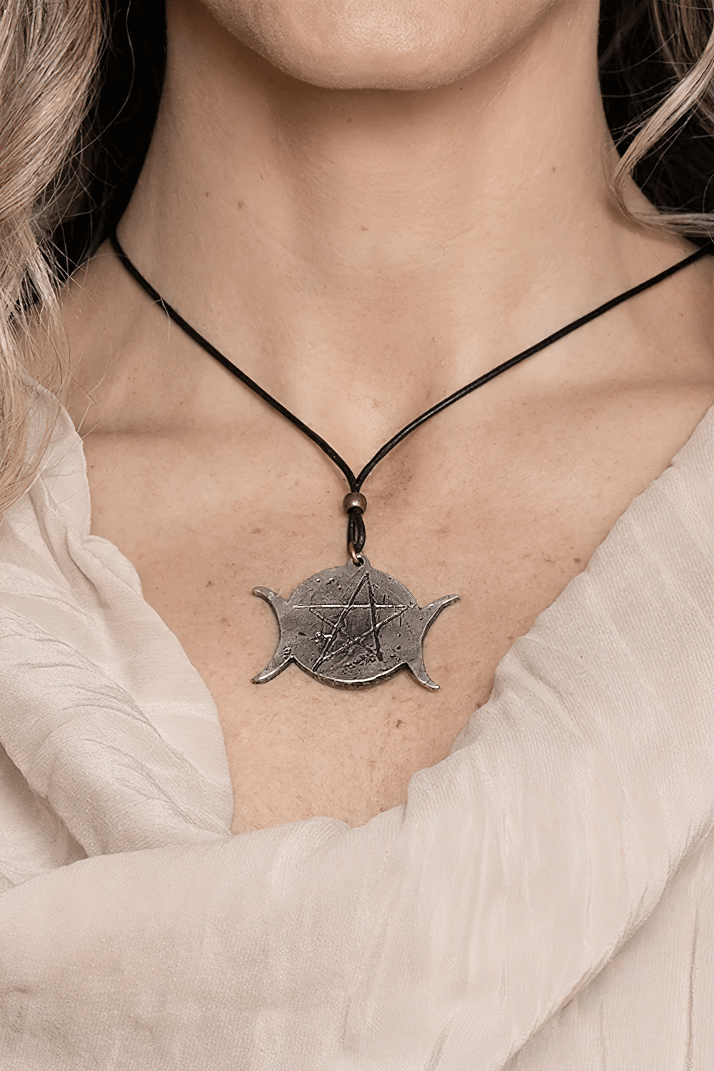 Gothic Triple Moon Pentagram Wiccan Amulet Necklace displayed on a woman with a flowing top.