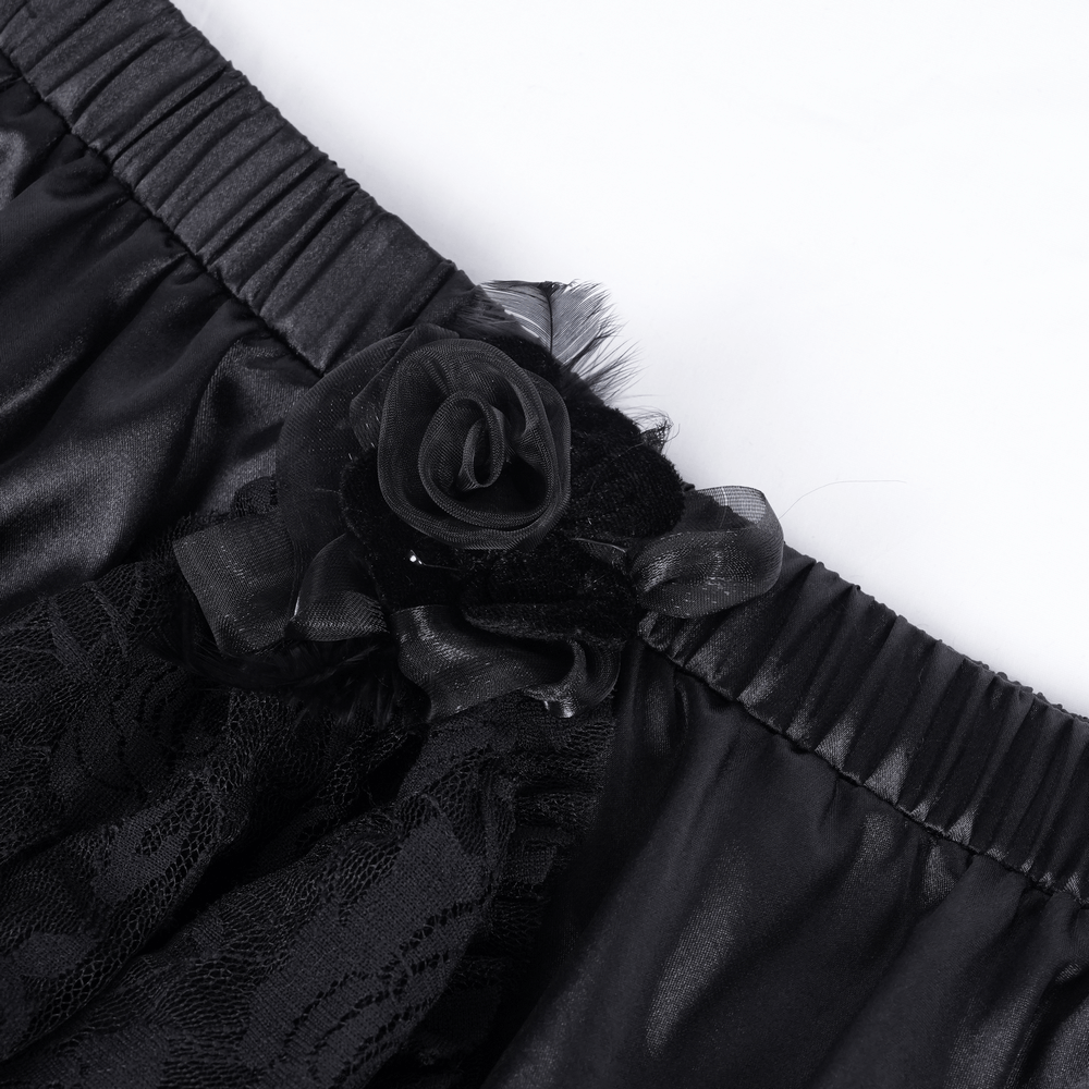 Close-up of a Gothic tulle skirt featuring black lace and a floral ribbon accent.