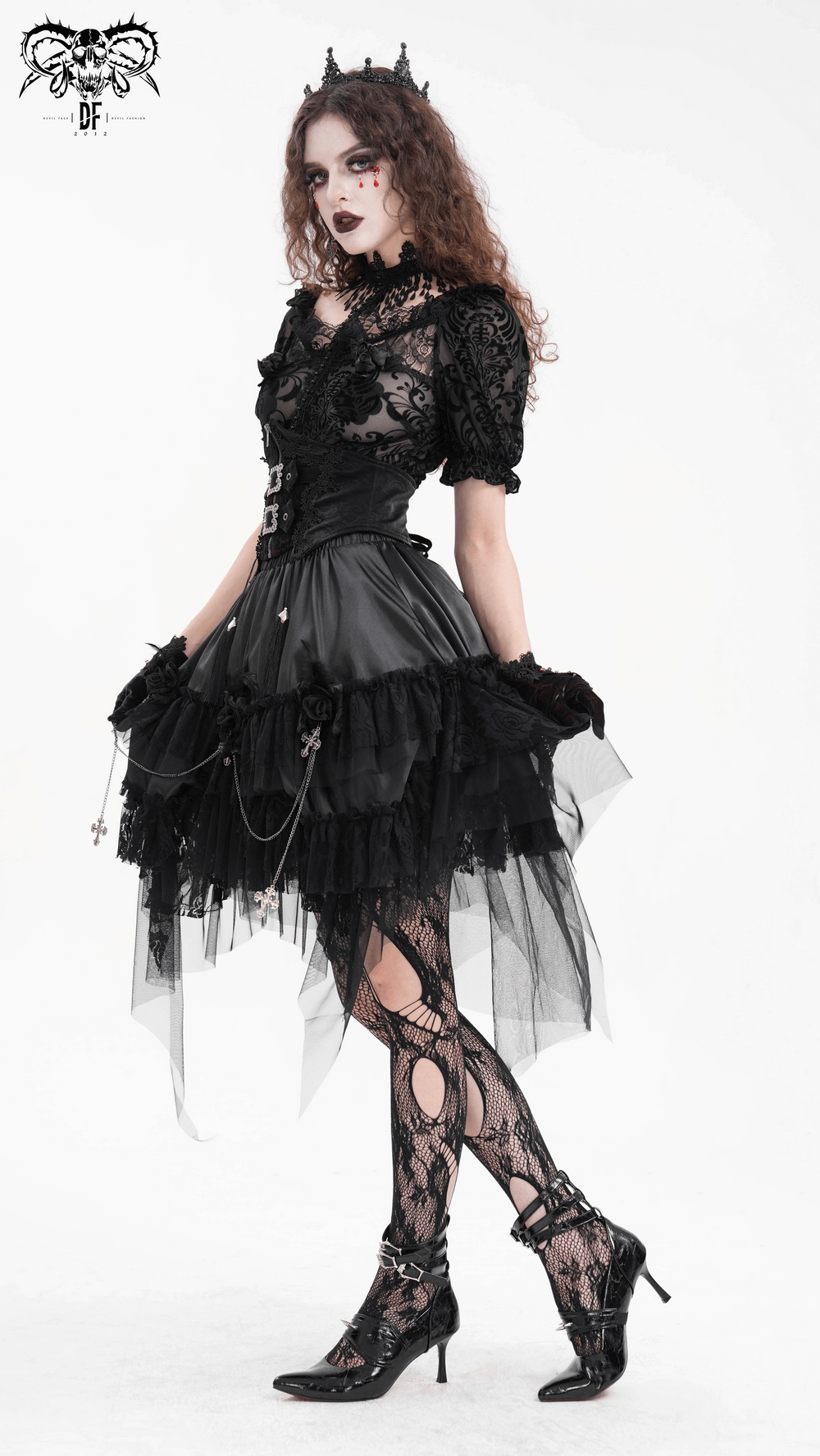 Gothic tulle skirt with lace details and chains, styled with a dramatic layered black design and edgy accessories.
