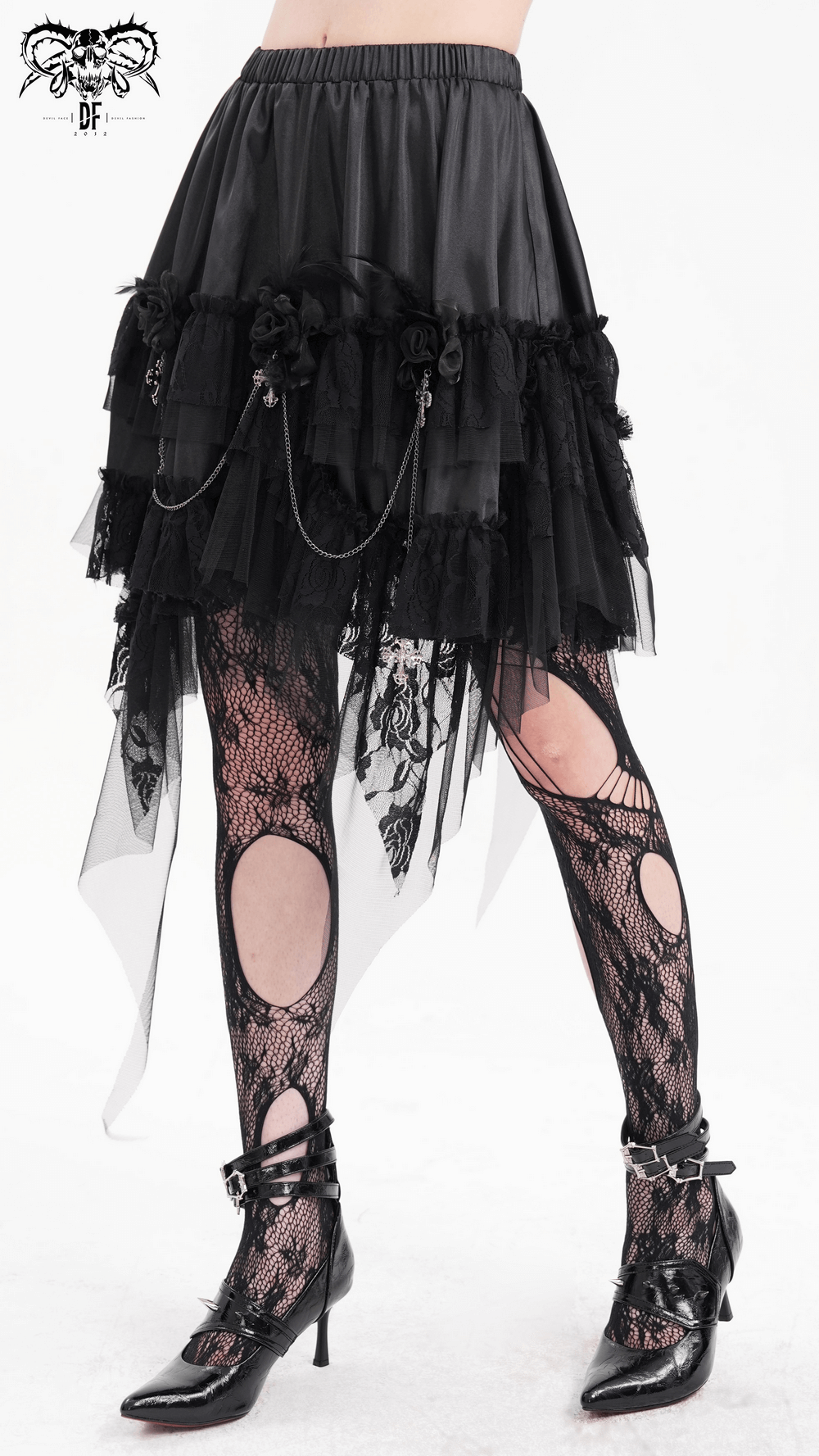 Layered black Gothic tulle skirt with lace details and chains, paired with stylish lace tights and chic heels.