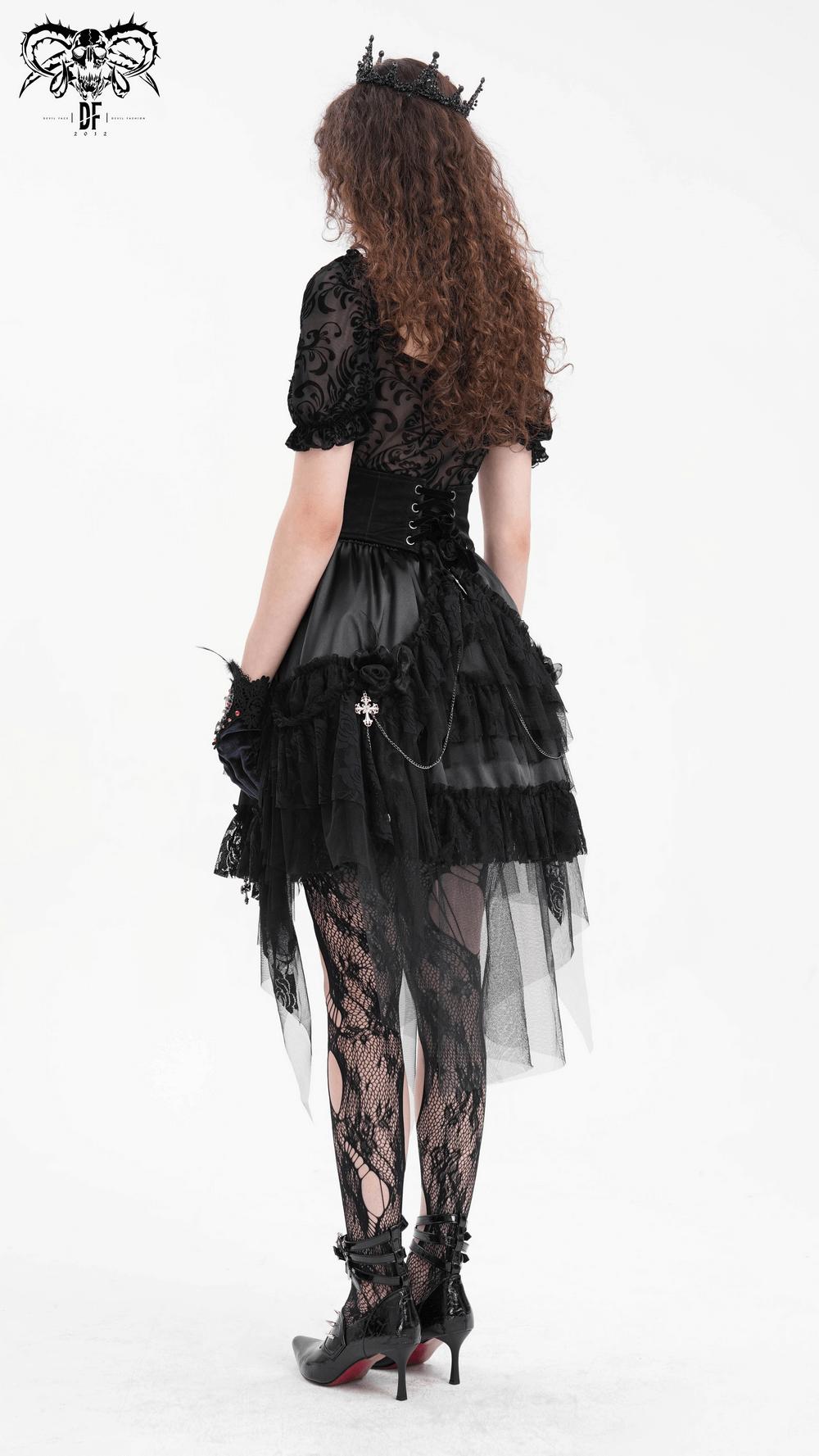 Woman wearing a Gothic tulle skirt with lace details and chains, showcasing an edgy and elegant alternative fashion style.