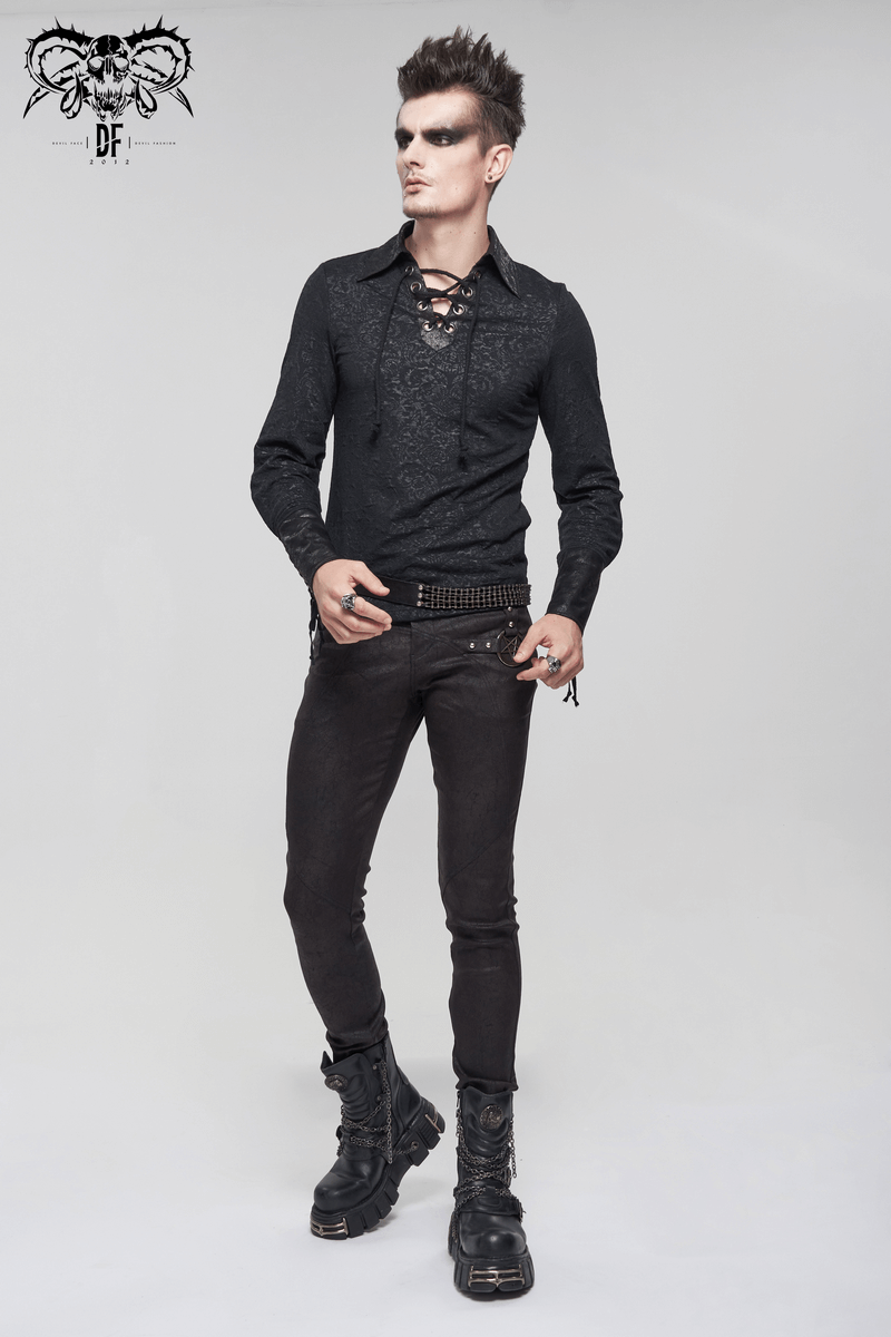 Stylish man in gothic black shirt with lace-up detailing and vintage cut, paired with black jeans and boots.
