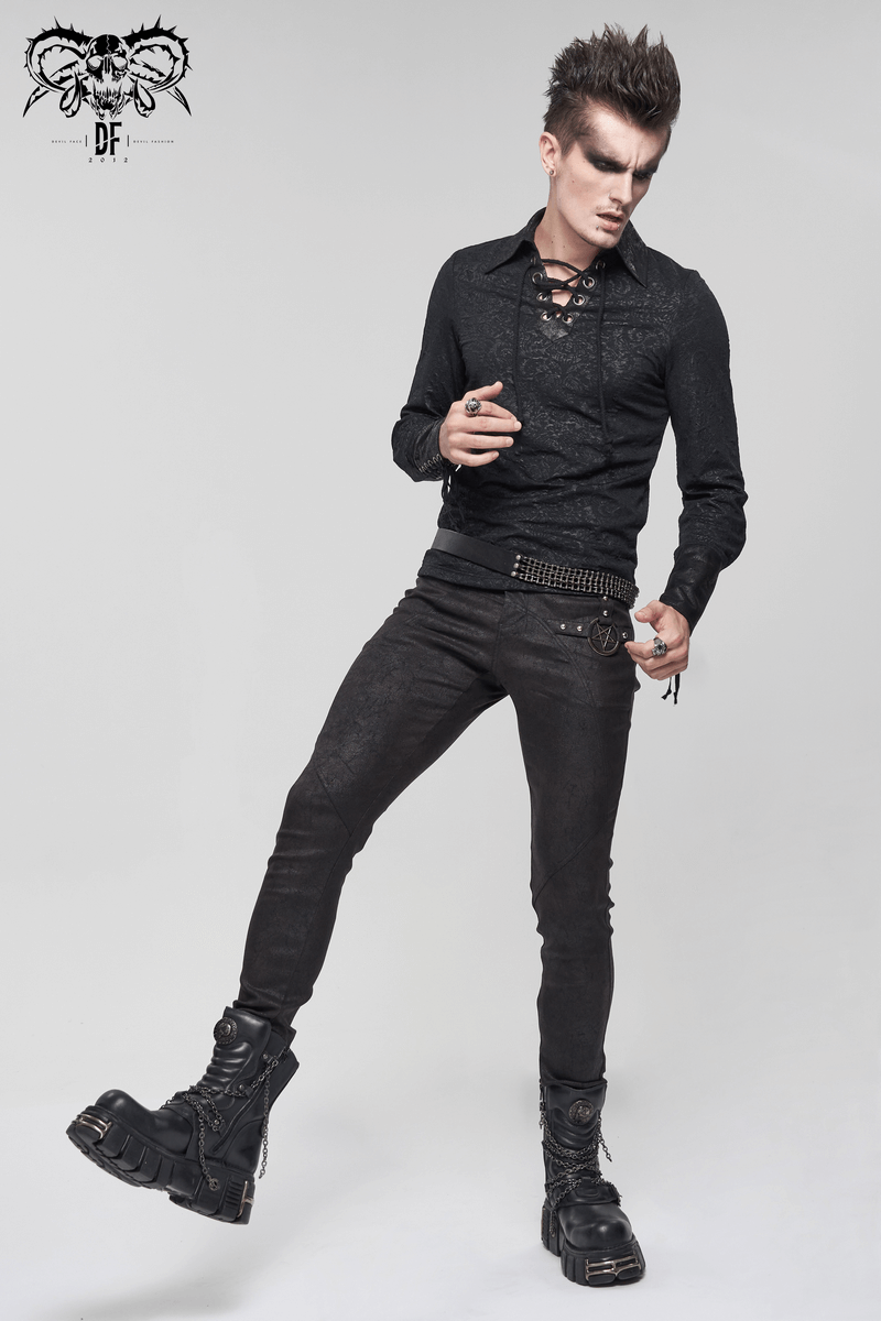 Stylish man wearing a black gothic lace-up shirt and slim jeans, showcasing a vintage gothic fashion look.