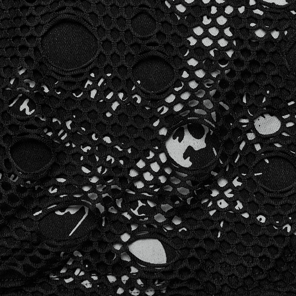 Close-up of black mesh fabric with skull prints, showcasing edgy design and unique texture for gothic fashion.
