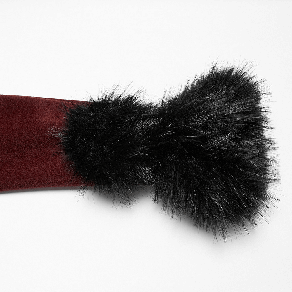 Close-up of a luxurious black fur collar attached to a red gothic coat.