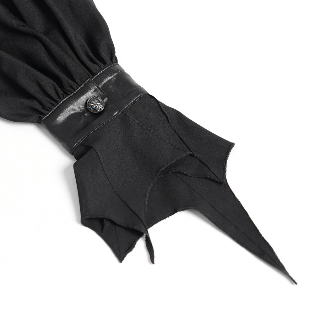 Close-up of the pointed cuff of a Gothic vampire bat wing blouse with faux leather and button detail.