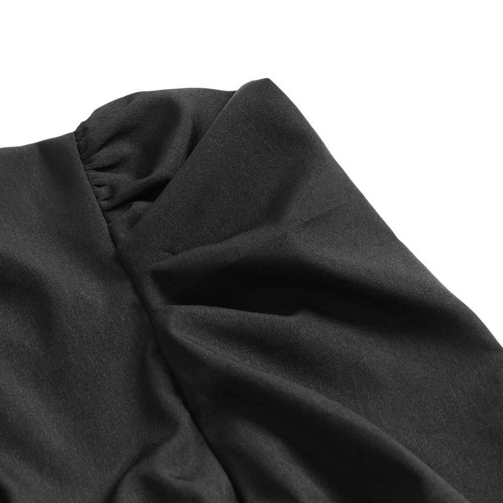 Close-up of black fabric showcasing the elegant texture of a gothic blouse with ruched detailing.