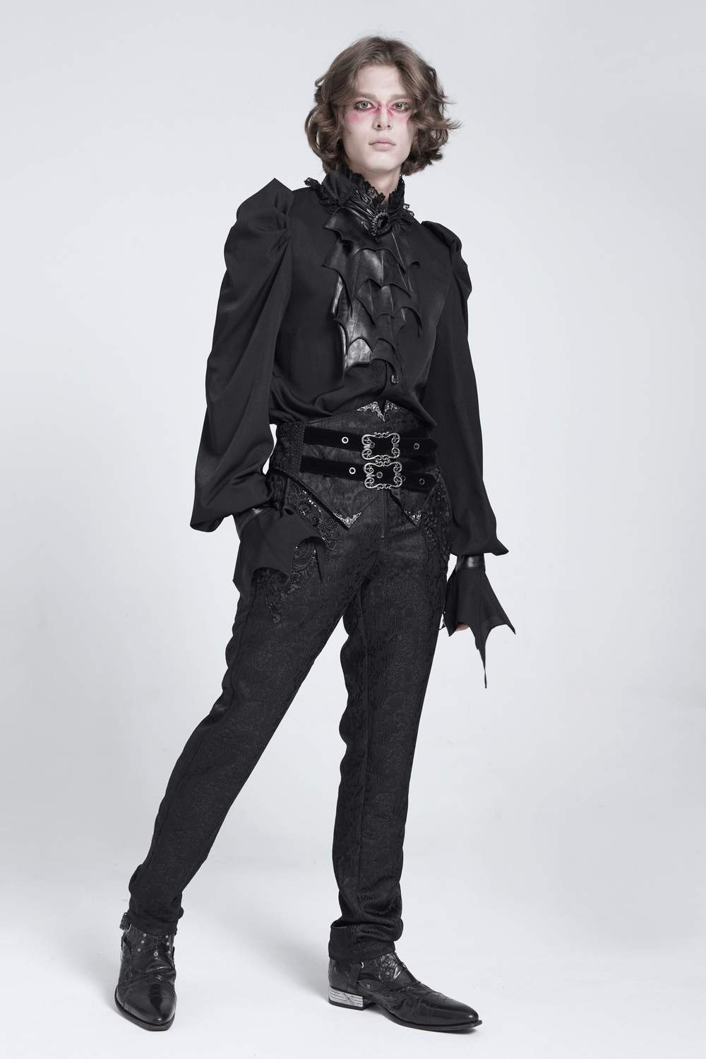 Gothic vampire bat wing blouse with lace collar, paired with ornate black trousers for a dramatic look.
